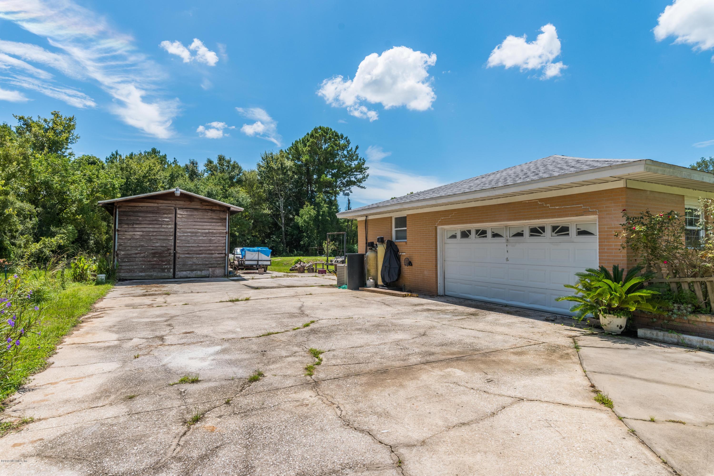 54152 Snyder Road Callahan, FL 32011 - Photo 32 of 39 a view of a house with a yard and a garage