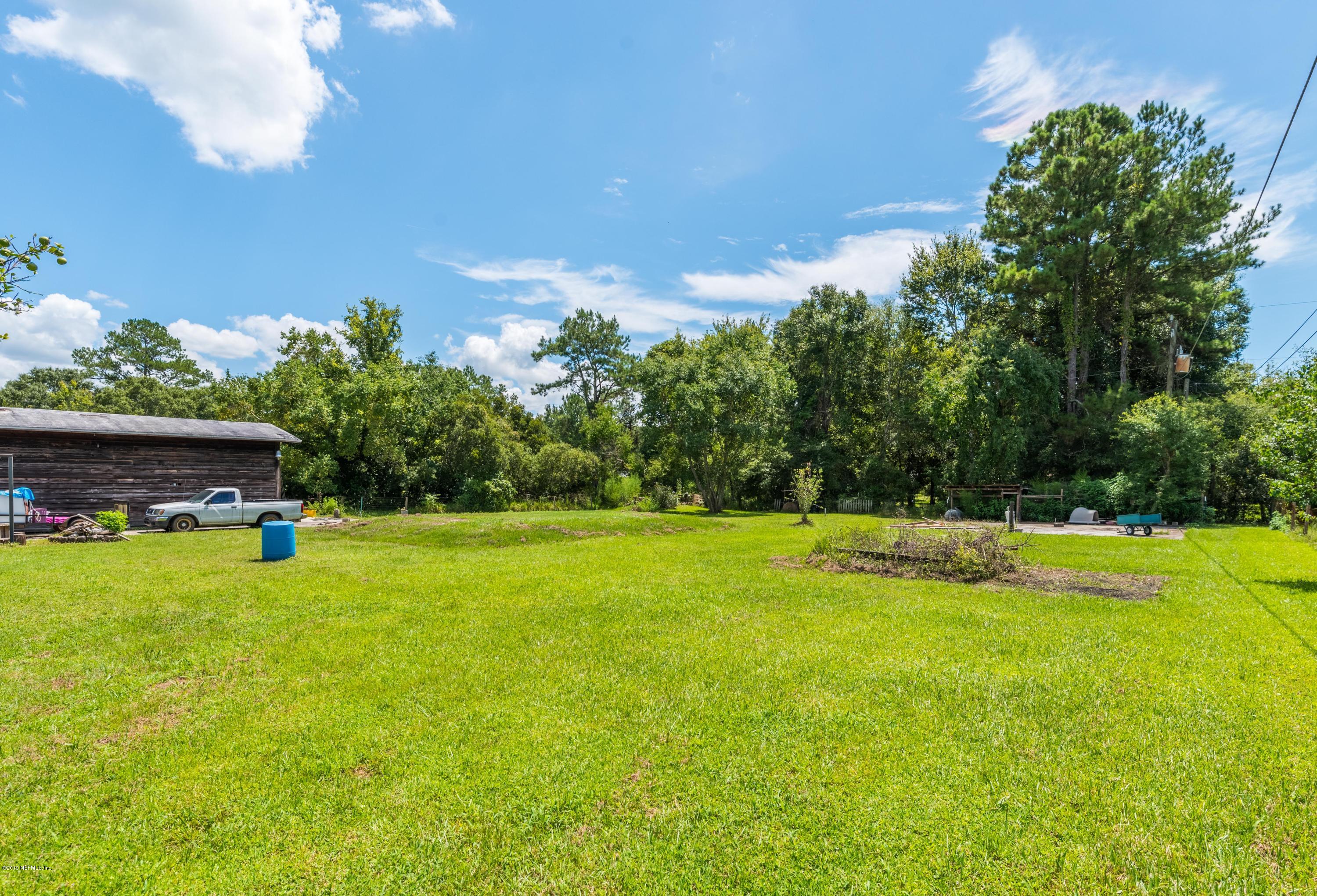 54152 Snyder Road Callahan, FL 32011 - Photo 34 of 39 a view of a swimming pool with an outdoor space and seating area