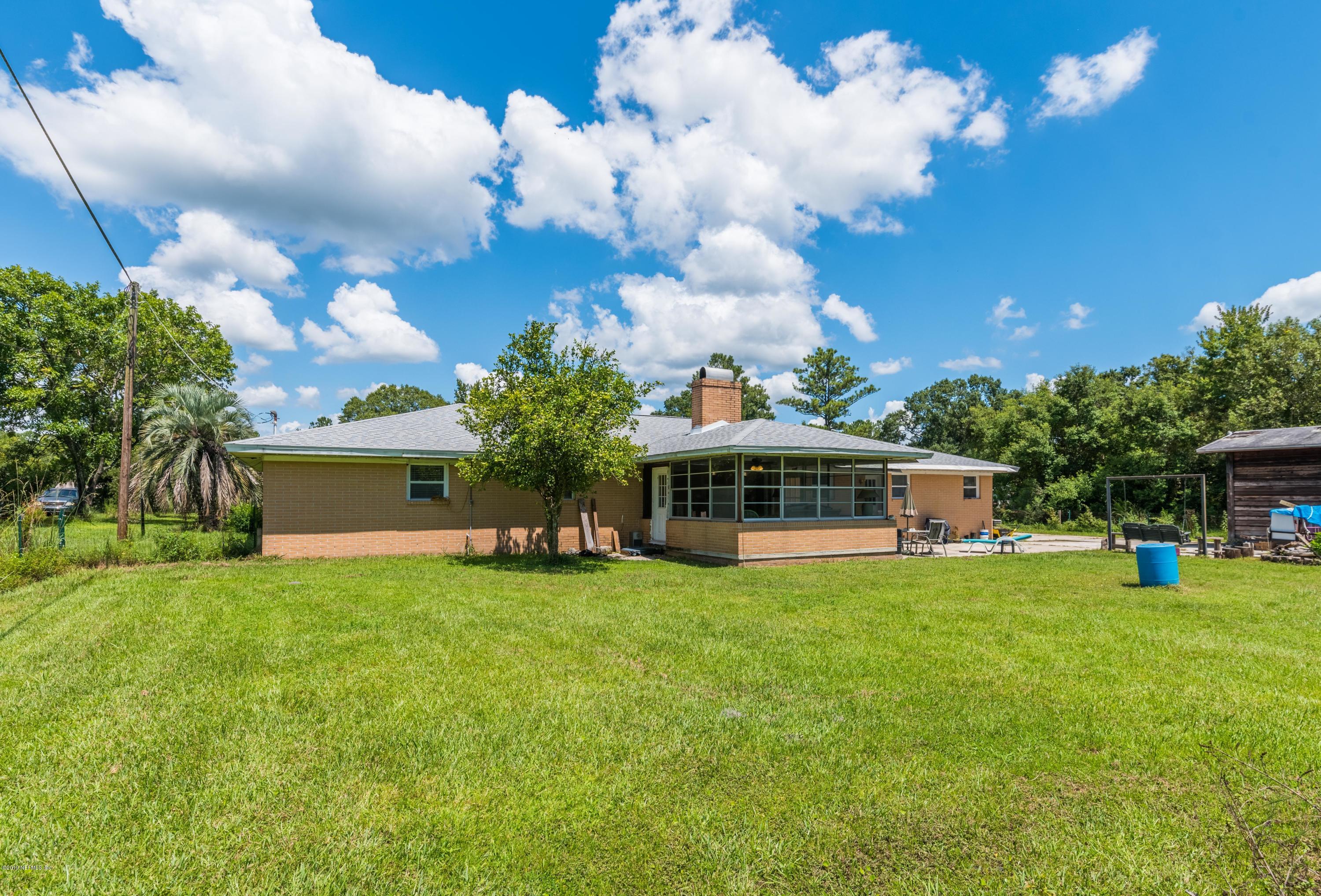 54152 Snyder Road Callahan, FL 32011 - Photo 35 of 39 a view of a house with a yard and sitting area