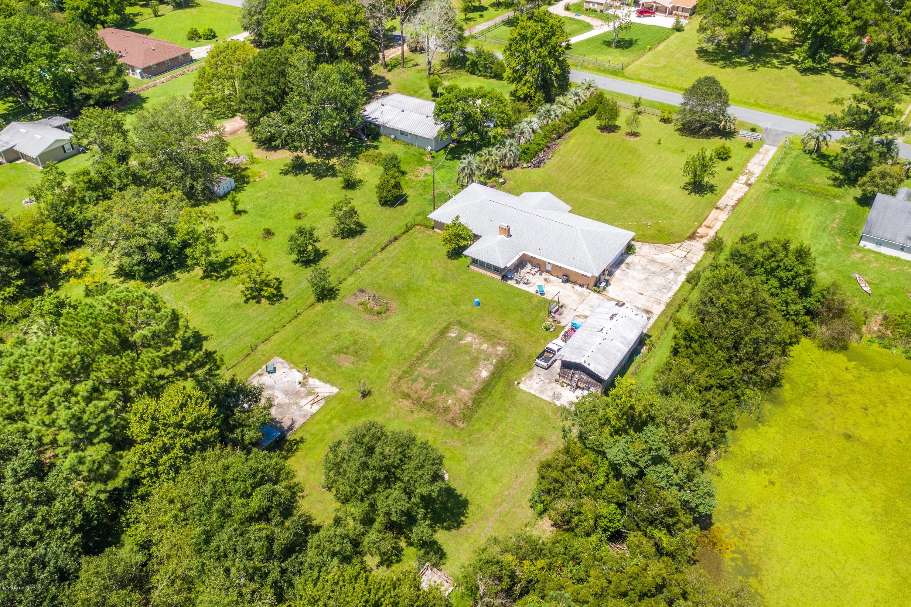 54152 Snyder Road Callahan, FL 32011 - Photo 36 of 39 an aerial view of residential house with swimming pool and lawn chairs
