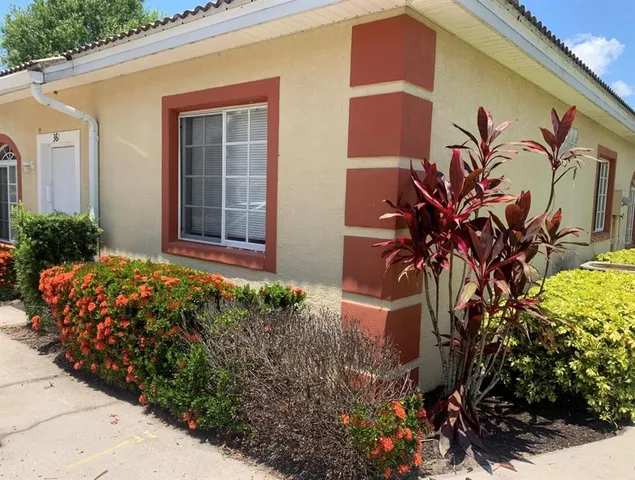 a vase with flowers sitting in front of a door