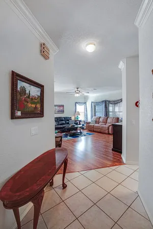 a living room with furniture ceiling fan and a wooden floor