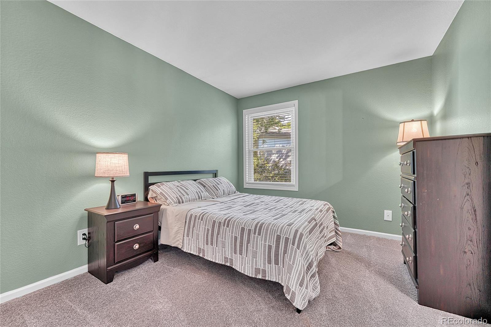 6722 Eagle Place Highlands Ranch, CO 80130 - Photo 26 of 47 a bedroom with a bed and a night stand