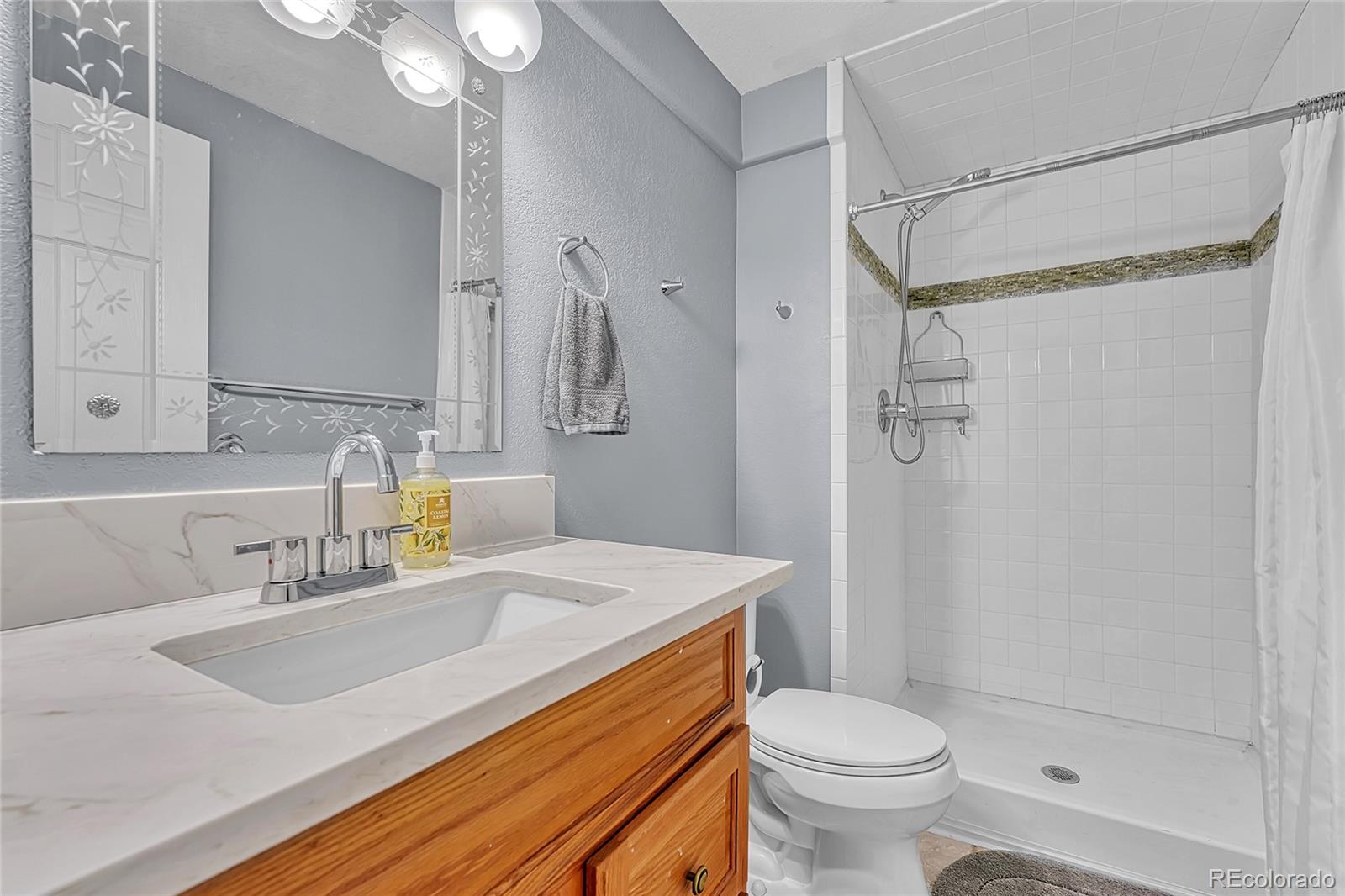 6722 Eagle Place Highlands Ranch, CO 80130 - Photo 29 of 47 a bathroom with a sink toilet and shower