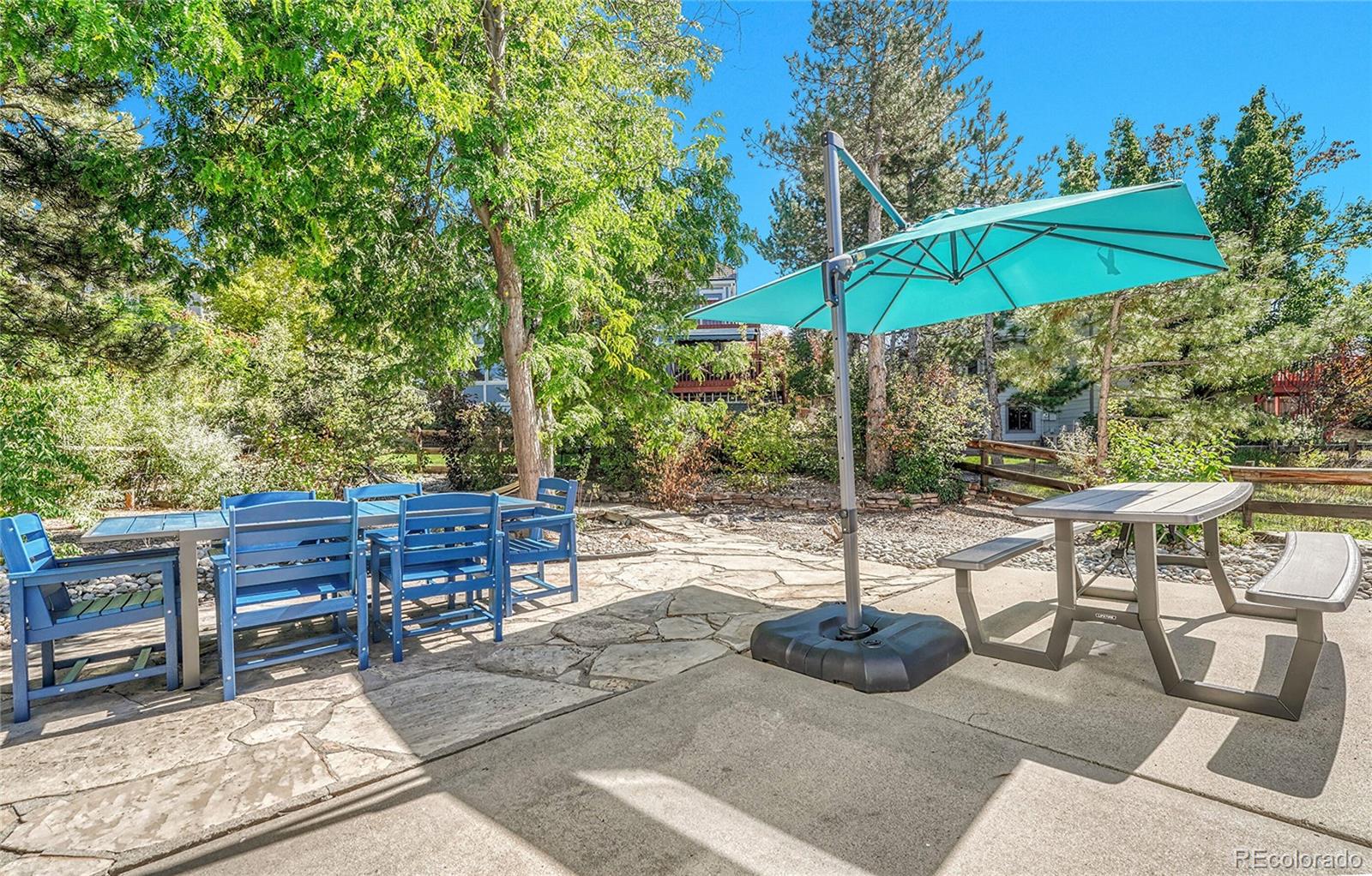 6722 Eagle Place Highlands Ranch, CO 80130 - Photo 32 of 47 a backyard view of a house with table and chairs