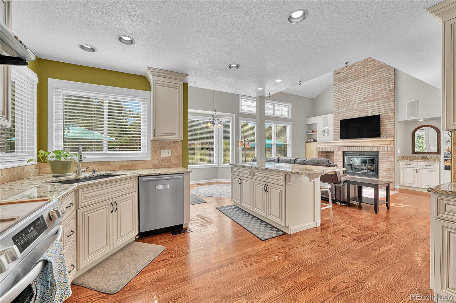6722 Eagle Place Highlands Ranch, CO 80130 - Photo 4 of 47 a large kitchen with stainless steel appliances granite countertop a stove and a sink