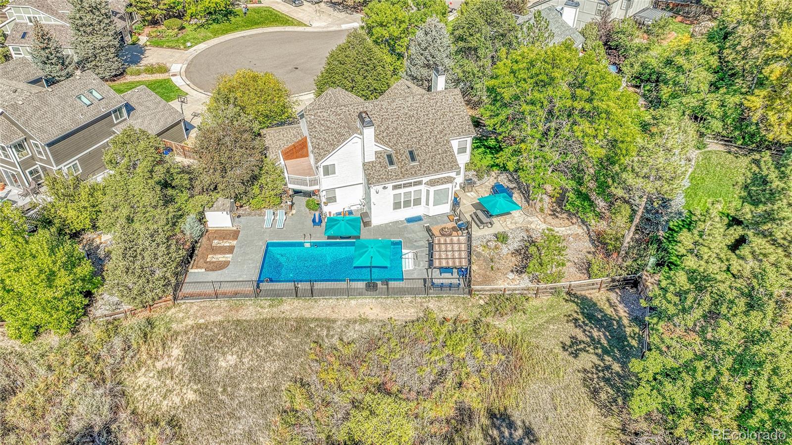 6722 Eagle Place Highlands Ranch, CO 80130 - Photo 42 of 47 an aerial view of a house with a yard and large trees