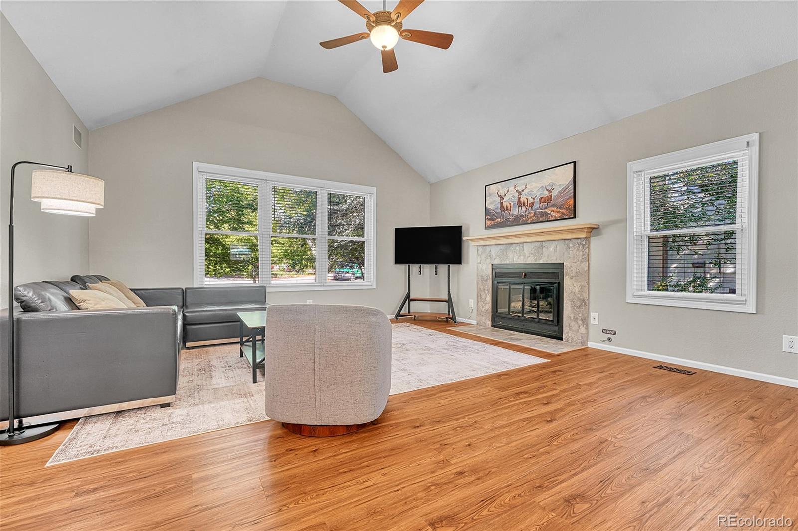 6722 Eagle Place Highlands Ranch, CO 80130 - Photo 7 of 47 a living room with furniture a fireplace and a window