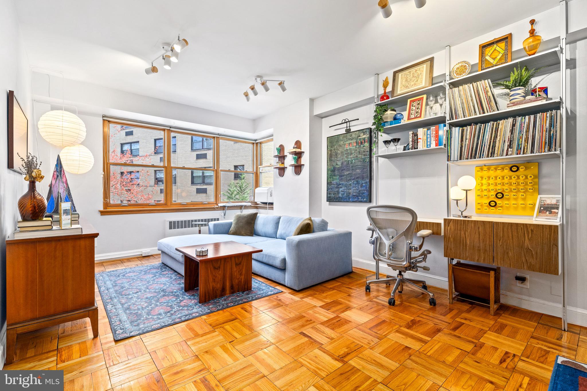3025 Ontario Road Northwest, Unit 207 Washington, DC 20009 - Photo 3 of 15 a living room with fireplace furniture and a window
