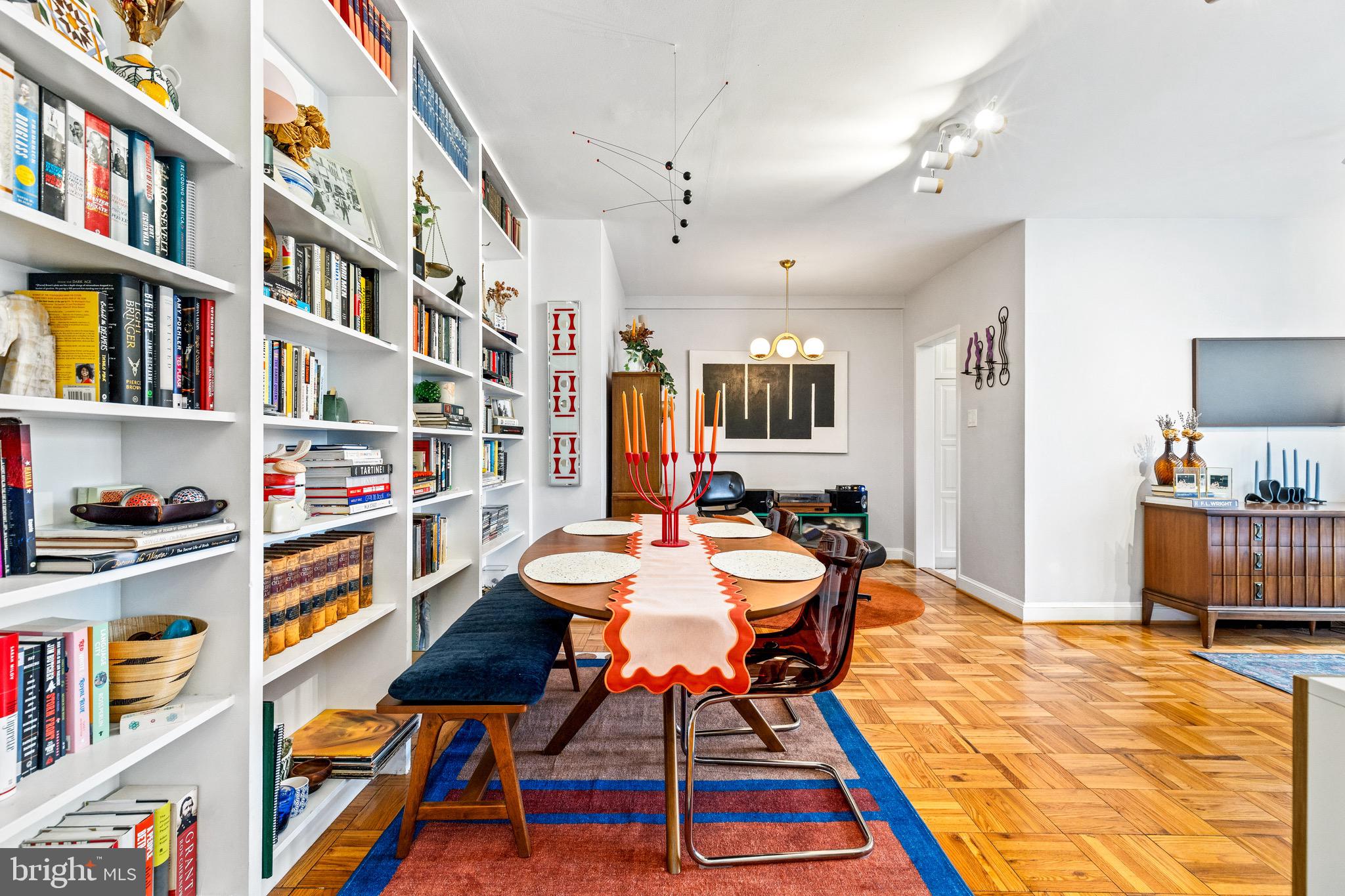 3025 Ontario Road Northwest, Unit 207 Washington, DC 20009 - Photo 7 of 15 a dining room with lots of furniture and a book shelf