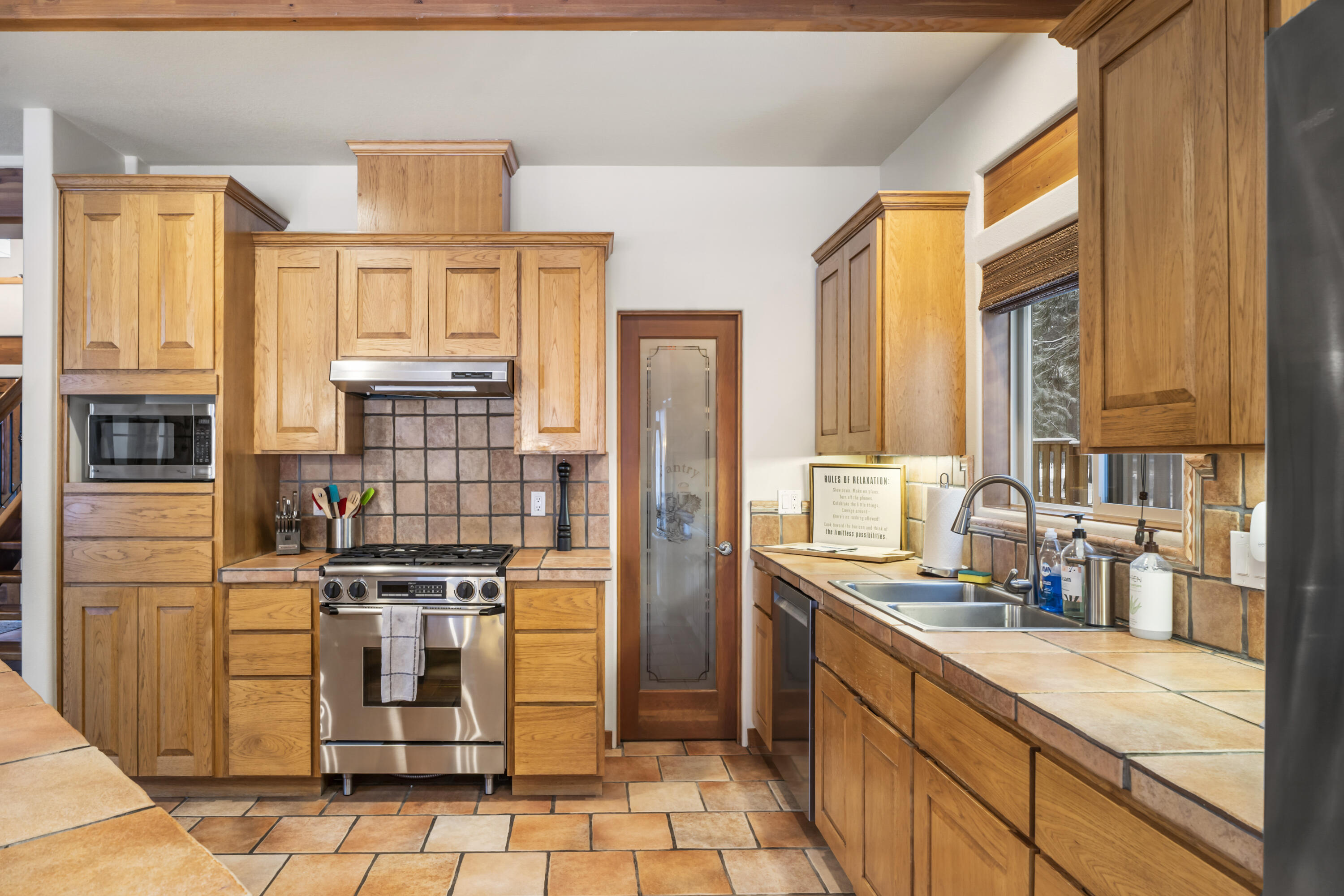 56065 Snow Goose Road Bend, OR 97707 - Photo 12 of 65 High-end stainless appliances. LOTS of storage space AND walk-in pantry! Stainless steel appliances, Gas stove w/range hood and walk in Pantry.