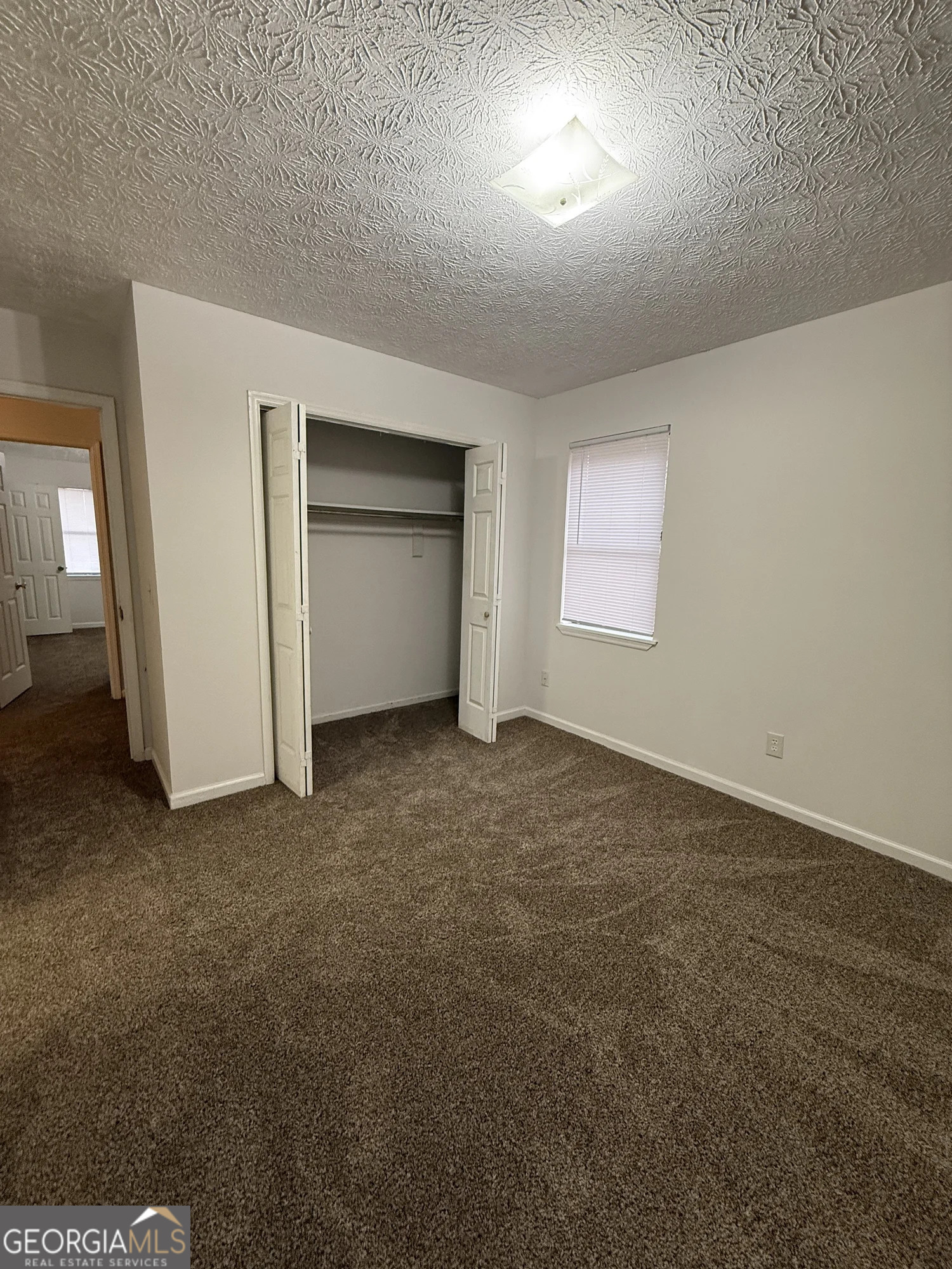 175 West Paces Drive Athens, GA 30605 - Photo 14 of 16 an empty room with a fireplace and painted walls