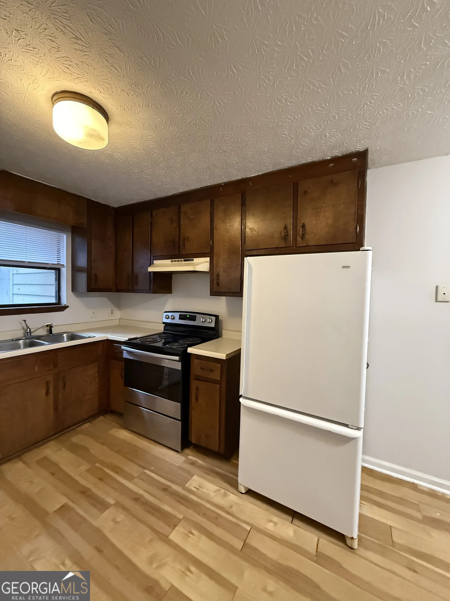 175 West Paces Drive Athens, GA 30605 - Photo 5 of 16 a kitchen with granite countertop a refrigerator and a stove top oven