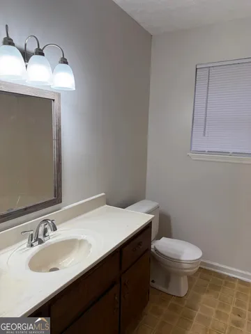 a bathroom with a sink toilet and vanity