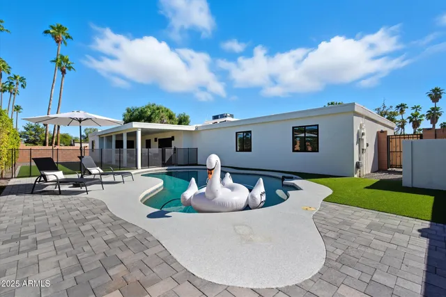 a view of a house with backyard sitting area and garden