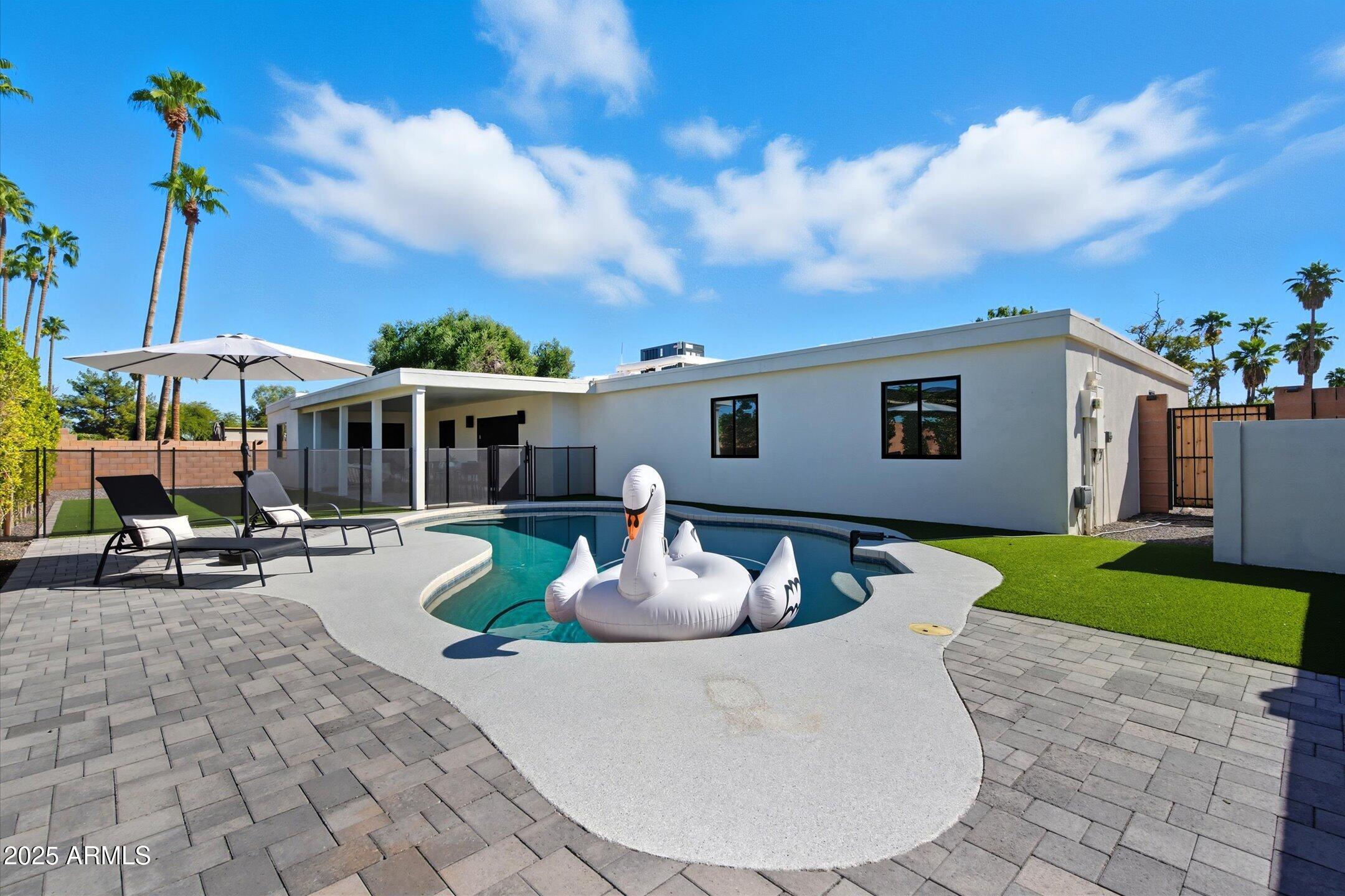 a view of a house with backyard sitting area and garden