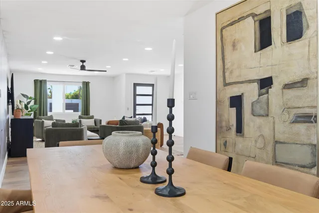 a living room with furniture a table and kitchen view
