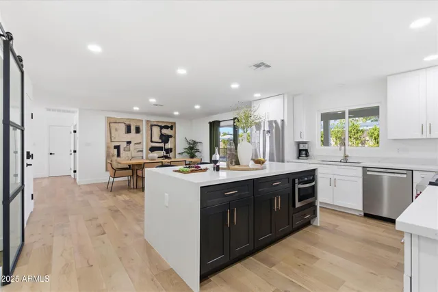 a kitchen with a sink stove and cabinets