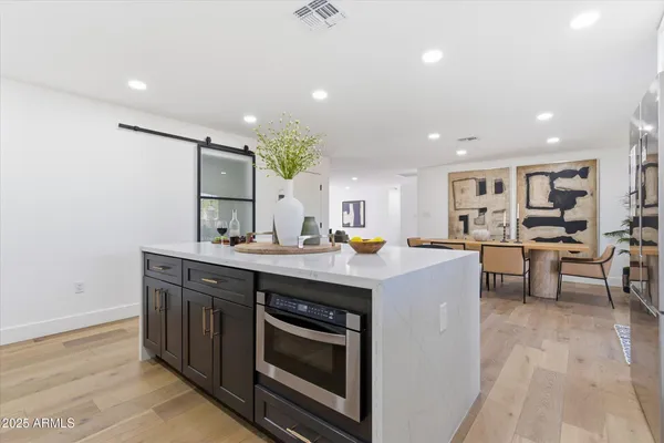 a kitchen with a sink stainless steel appliances and cabinets