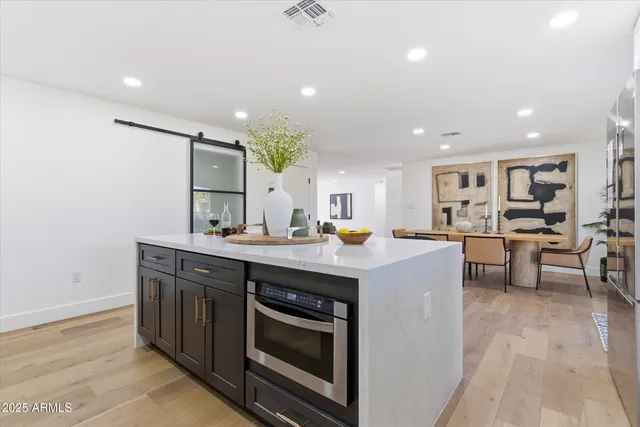 a kitchen with a sink stainless steel appliances and cabinets