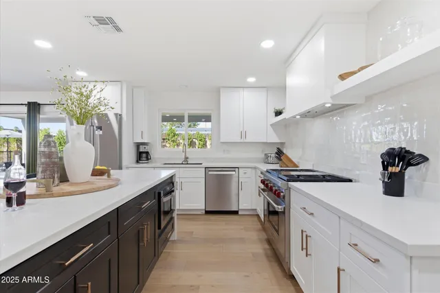 a kitchen with a sink stove and cabinets
