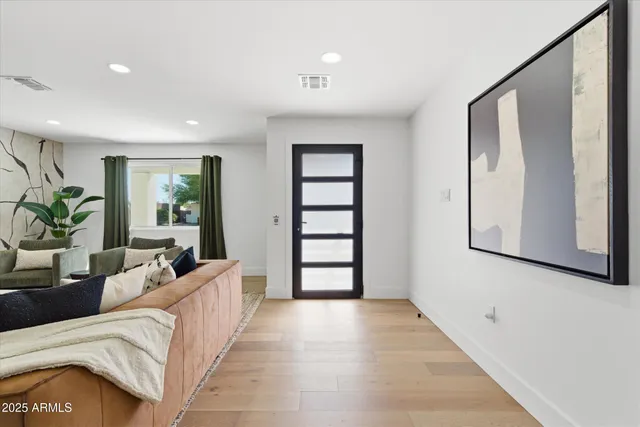 a living room with furniture and large window
