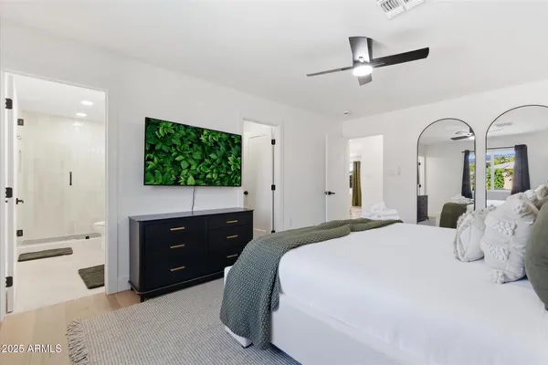 a bedroom with a bed and a dresser