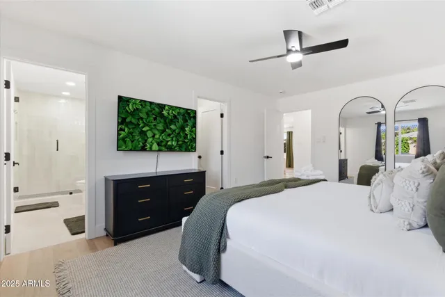 a bedroom with a bed and a dresser