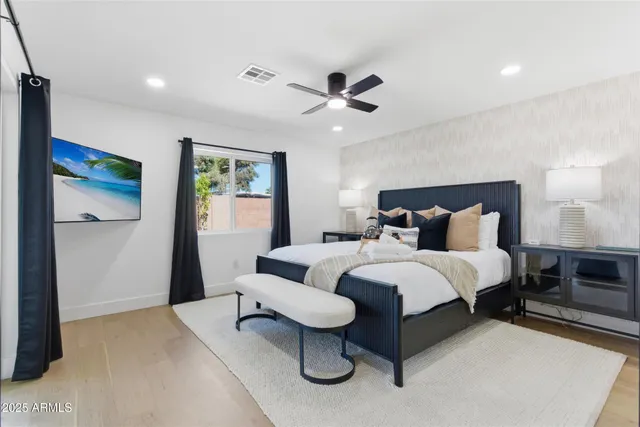 a bedroom with bed and a chandelier