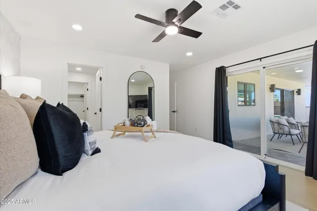 a bedroom with bed and a chandelier