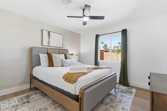 a bed room with a bed and a painting