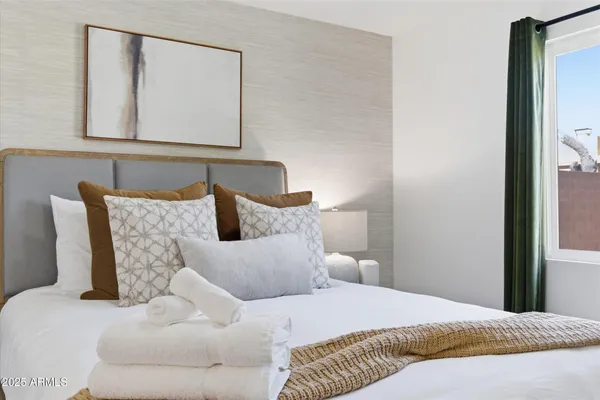 a bedroom with a bed and a mirror