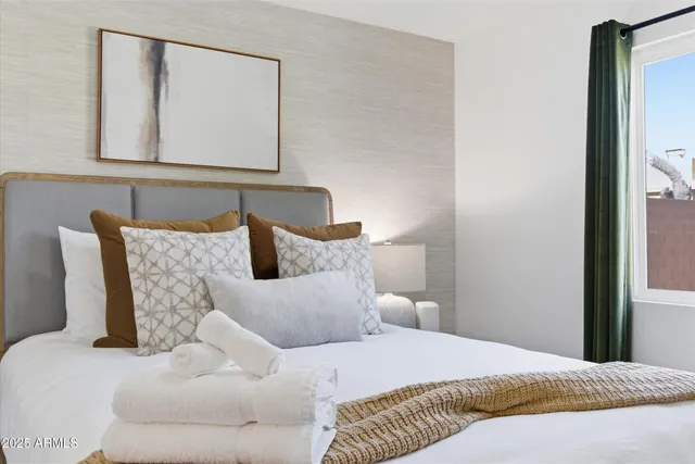 a bedroom with a bed and a mirror