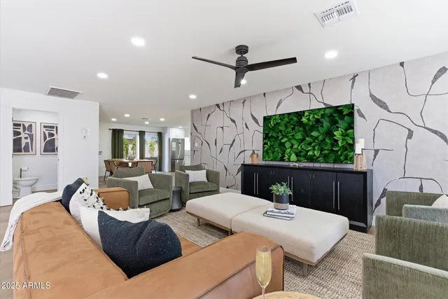a living room with furniture a ceiling fan and a window