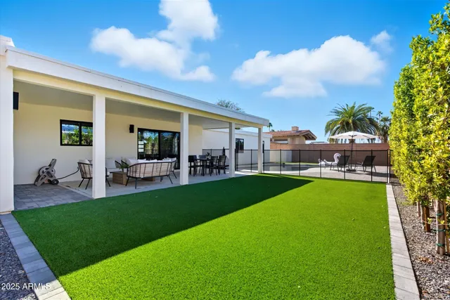 a roof deck with a table and chairs under an umbrella