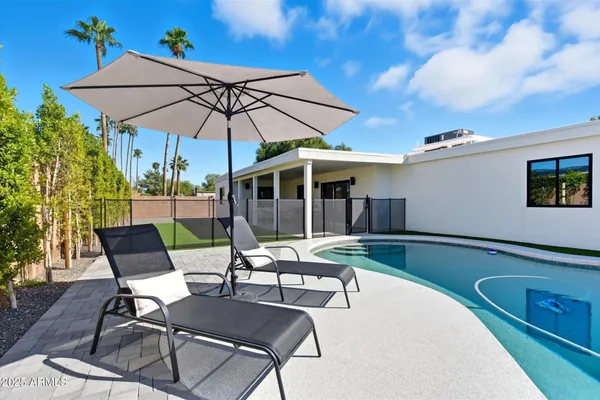 a view of a backyard with swimming pool