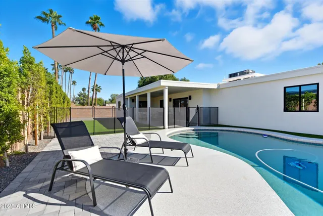 a view of a backyard with swimming pool