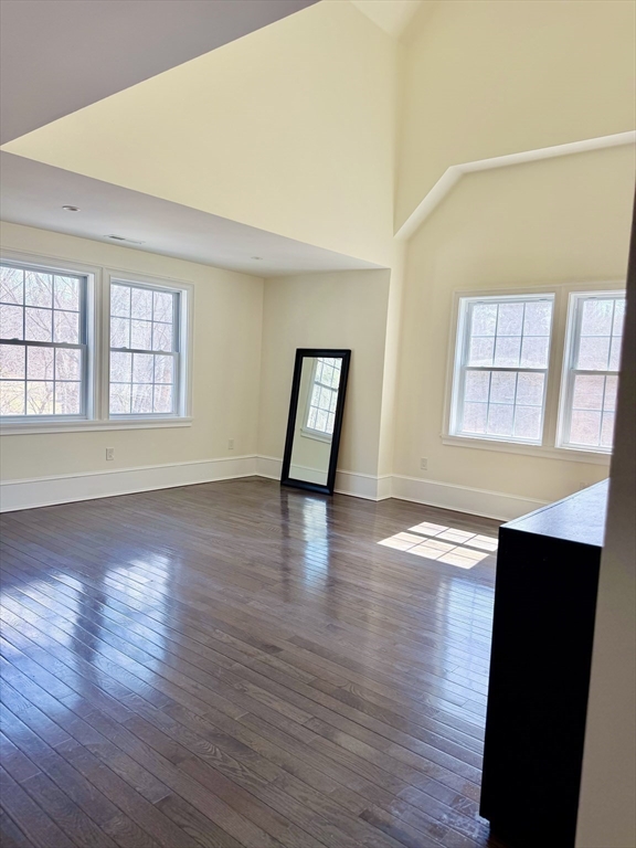 195 Lower Gore Road Webster, MA 01570 - Photo 11 of 24 an empty room with wooden floor and windows