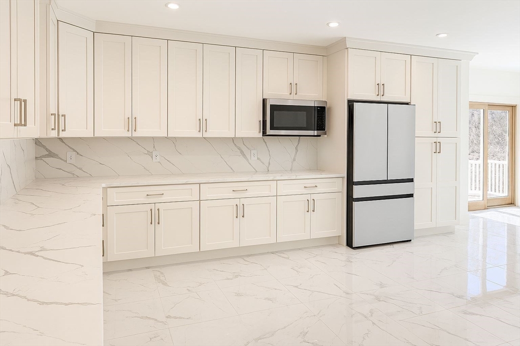 195 Lower Gore Road Webster, MA 01570 - Photo 3 of 24 a kitchen with white cabinets and refrigerator