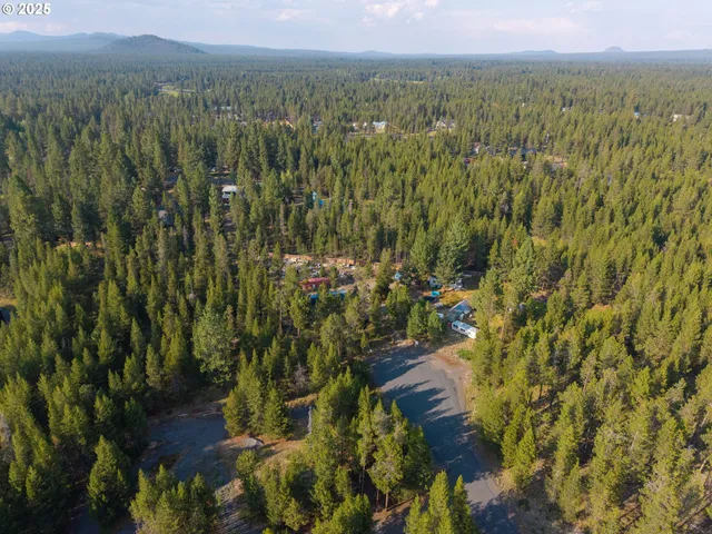 a backyard of a house with lots of green space and a lake view