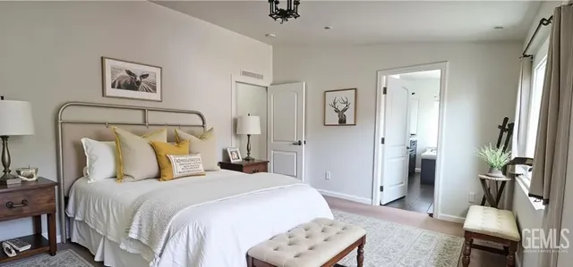 a bedroom with bed and wooden floor