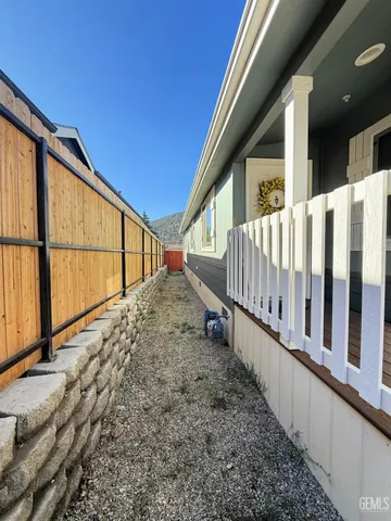 a view of wooden house with wooden fence