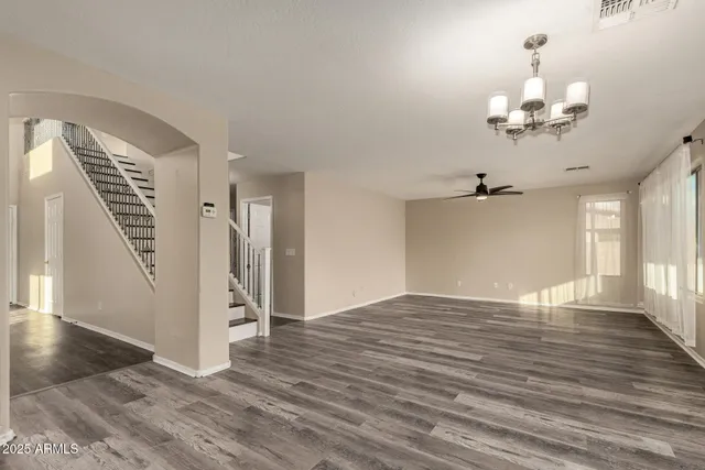 a view of an empty room and wooden floor