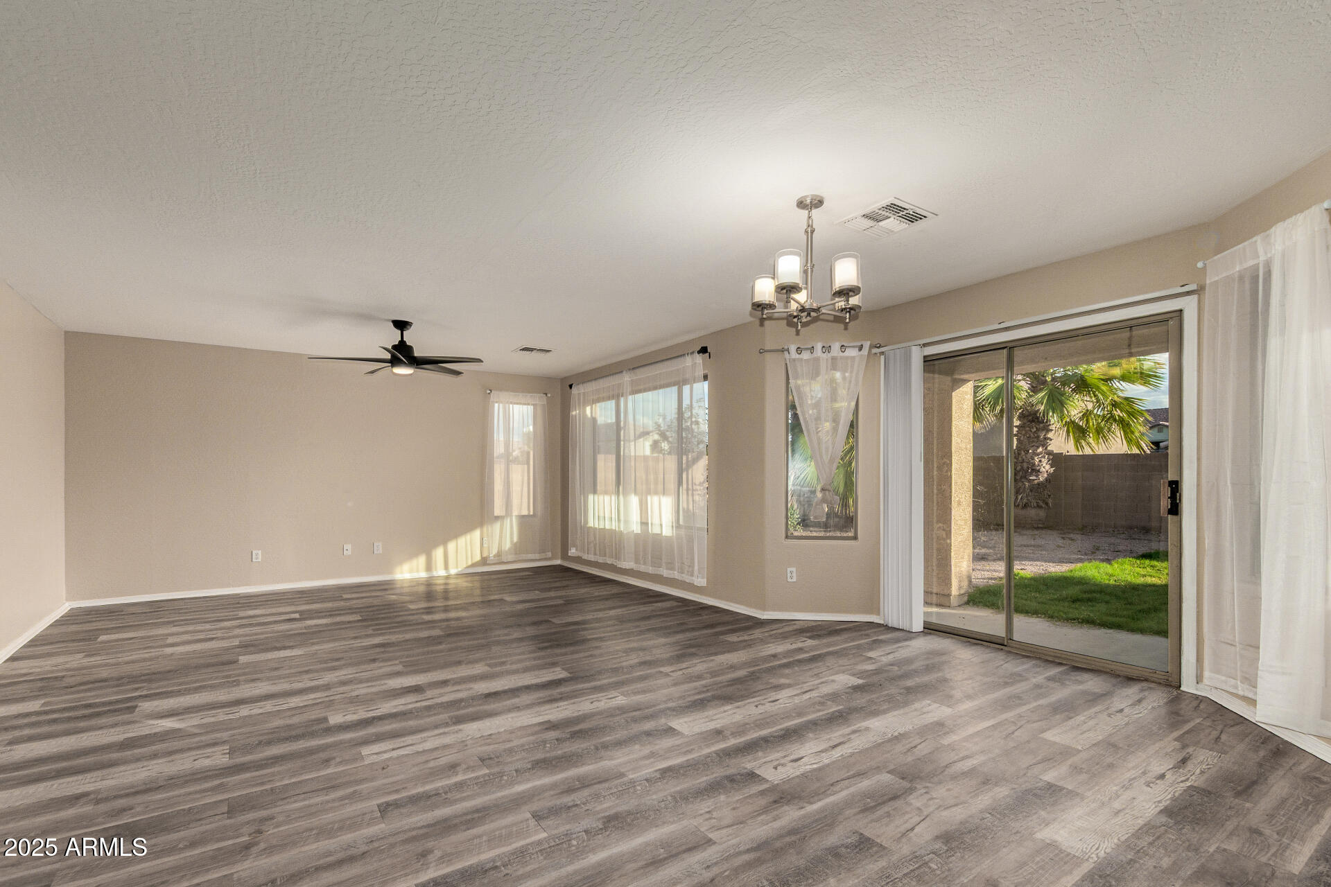 3545 East Crescent Way Gilbert, AZ 85298 - Photo 14 of 39 a view of an empty room with wooden floor and a window