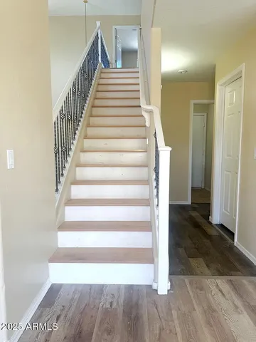 a view of an empty room and wooden floor