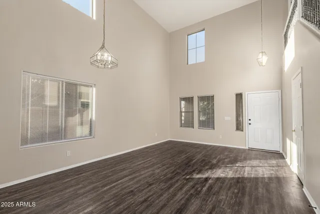 a view of a kitchen with a sink and dishwasher a refrigerator with wooden floor