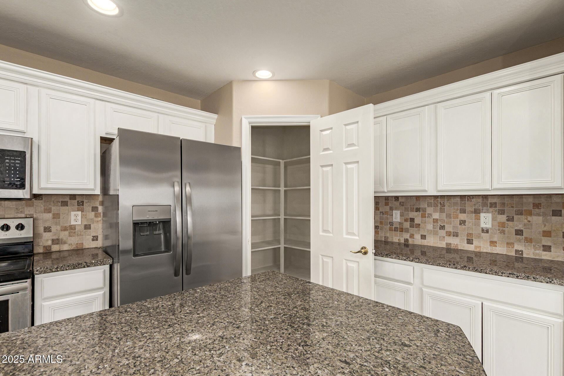 3545 East Crescent Way Gilbert, AZ 85298 - Photo 10 of 39 a kitchen with stainless steel appliances kitchen island granite countertop a refrigerator and a sink