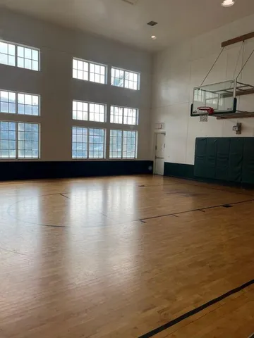 a view of a room with wooden floor and windows