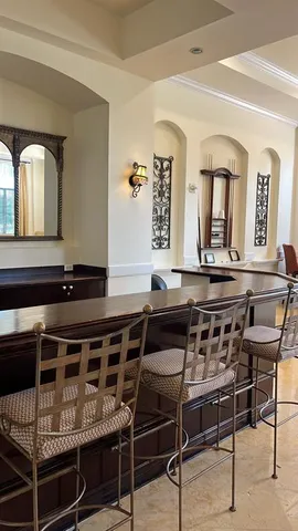 a kitchen with a stove a table and chairs in it