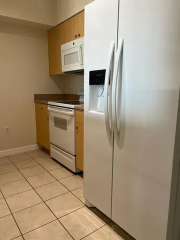 a kitchen with stainless steel appliances a refrigerator and a stove